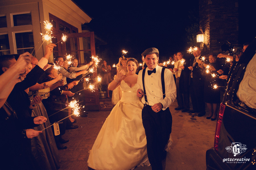 bride and groom exit through sparklers cliffs at glassy - wedding photography