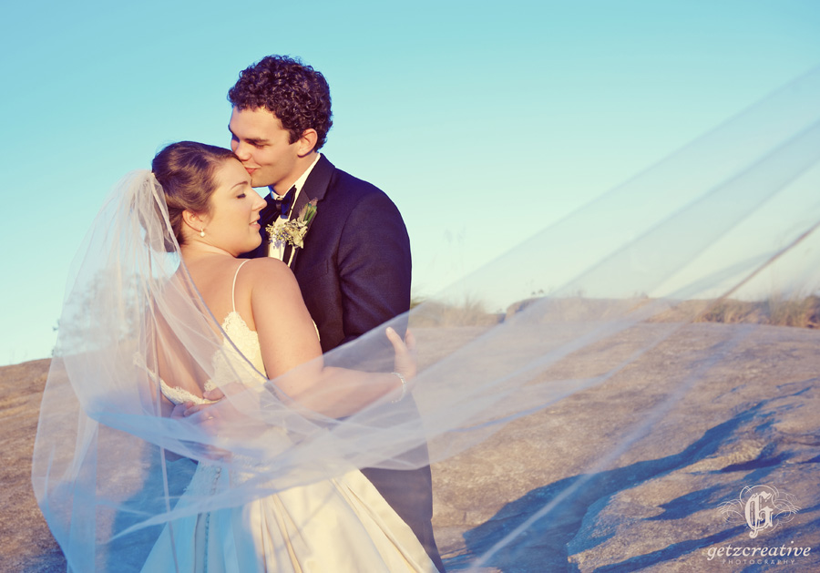 veil flowing bride & groom cliffs at glassy - wedding photography